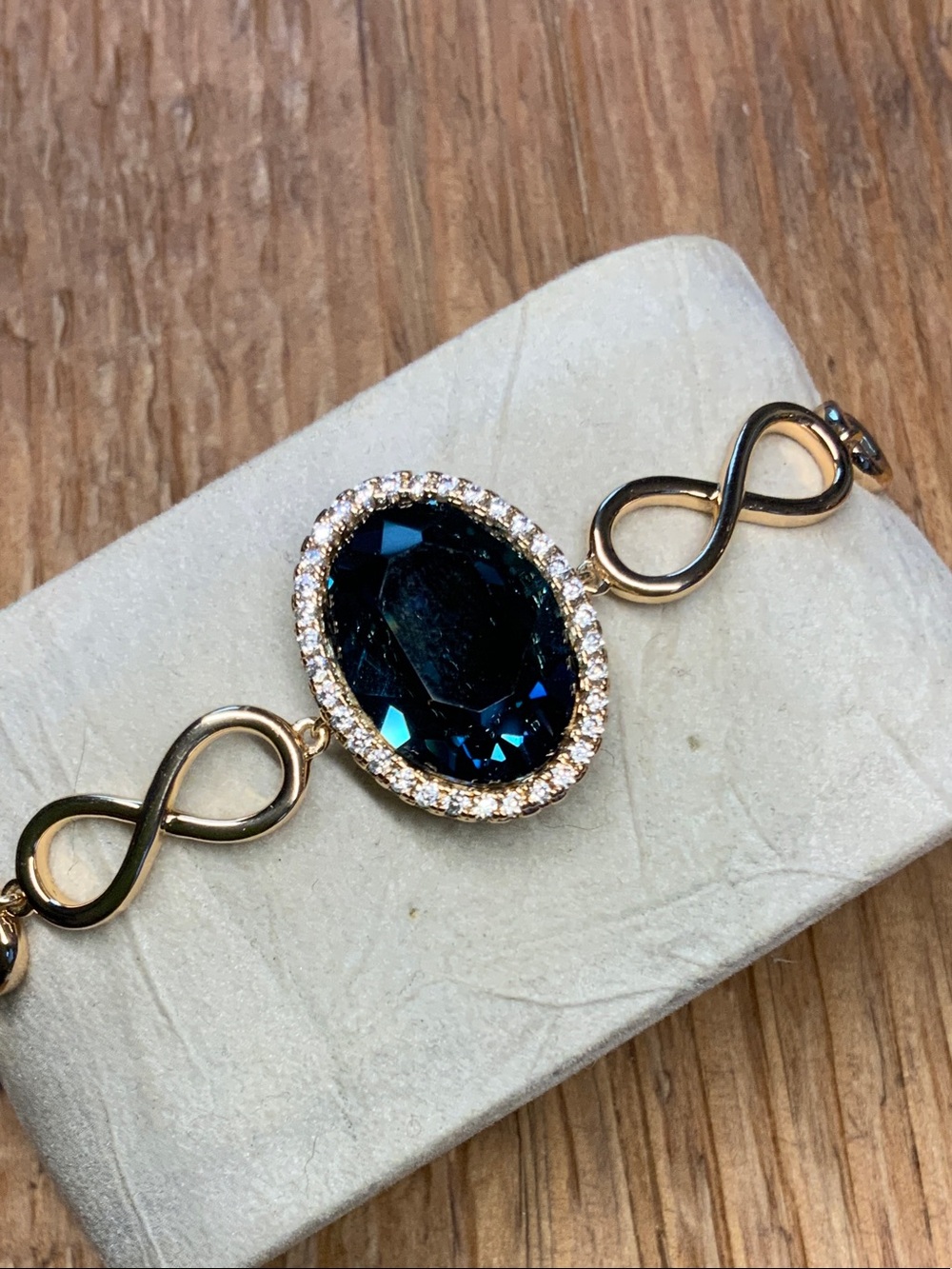 Deep Blue Oval Swarovski Crystal and Infinity Links Gold Tone Bracelet